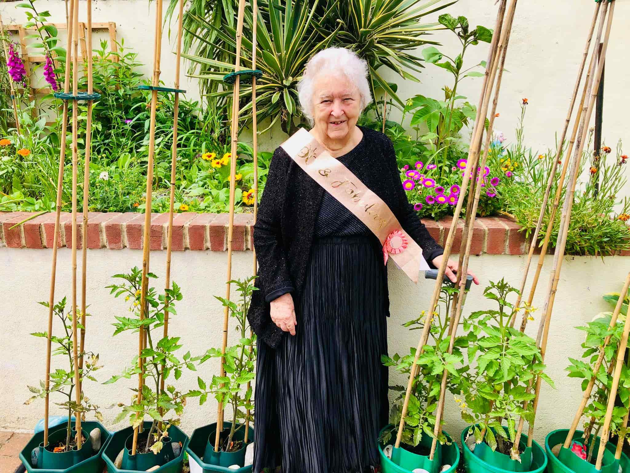 Resident celebrating her birthday in a garden