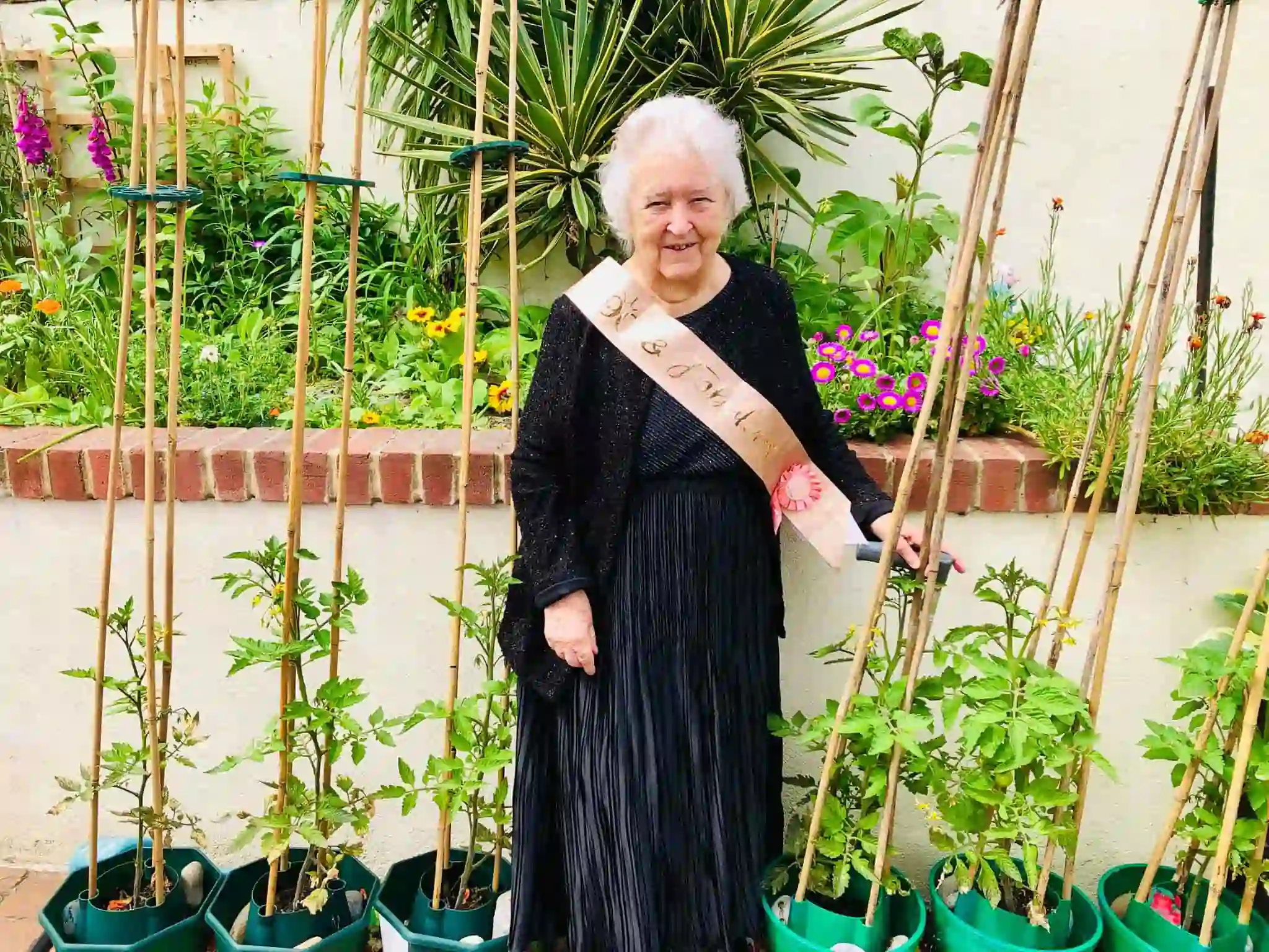 Resident celebrating her birthday in a garden