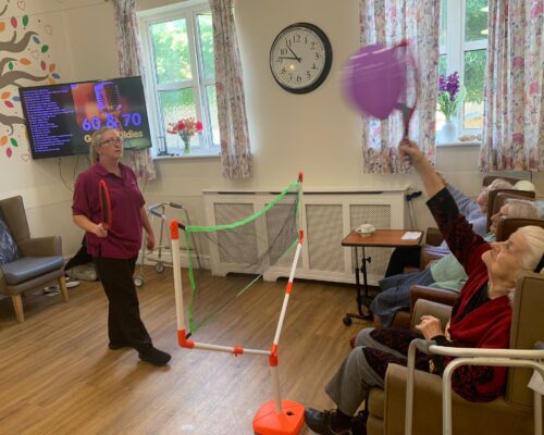 Residents and staff playing indoor sports games
