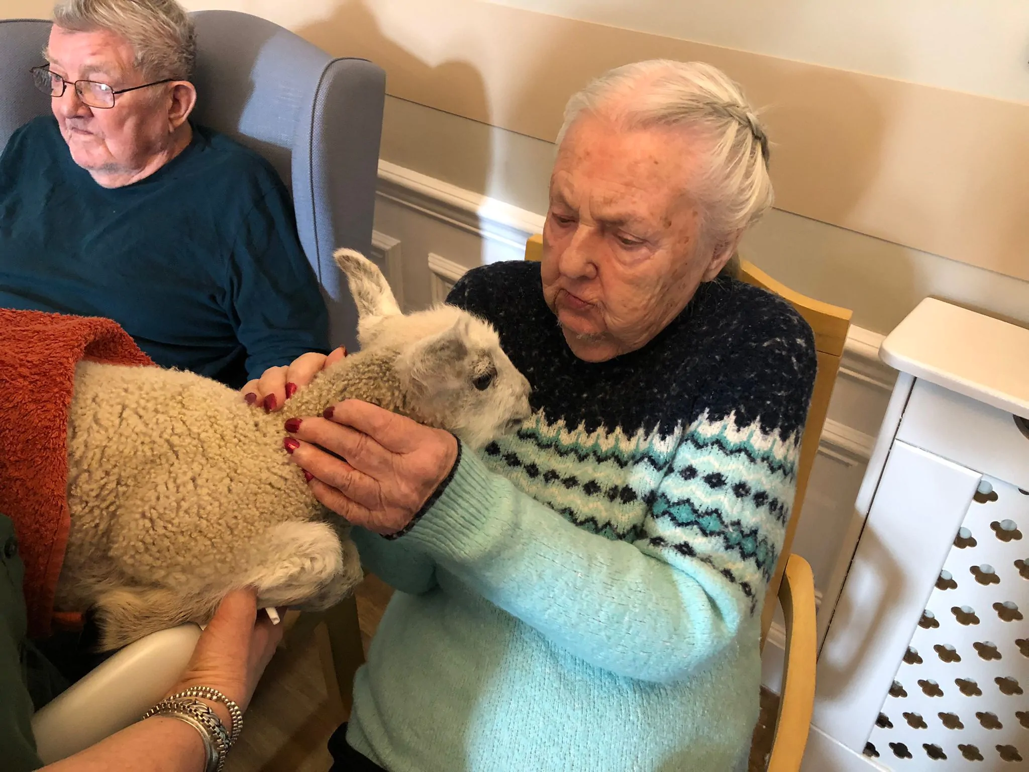 Resident holding a lamb