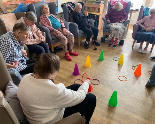 Residents playing Hoopla game indoors