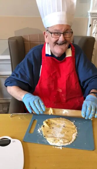 Resident rolling out pastry for baking