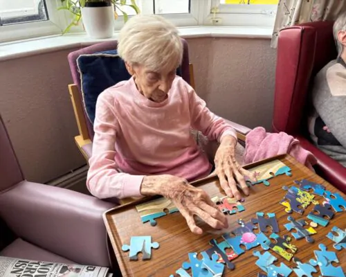 Resident doing jigsaw puzzle