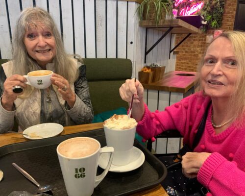 Two women drinking coffee on a shopping trip