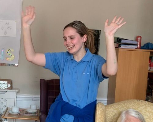 Staff member raising their hands up